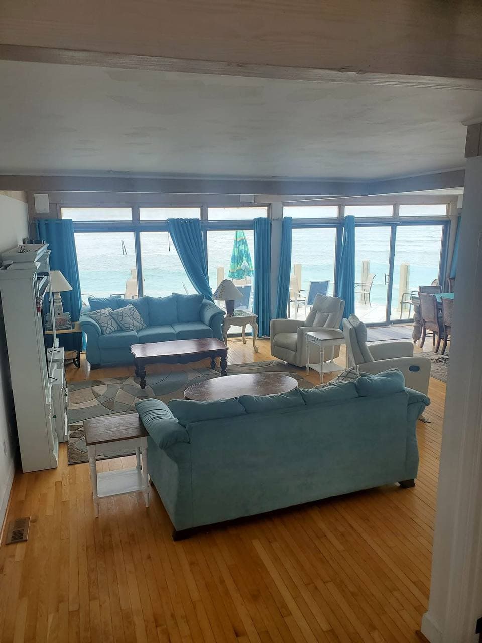 Coastal living room with teal sofas and ocean view