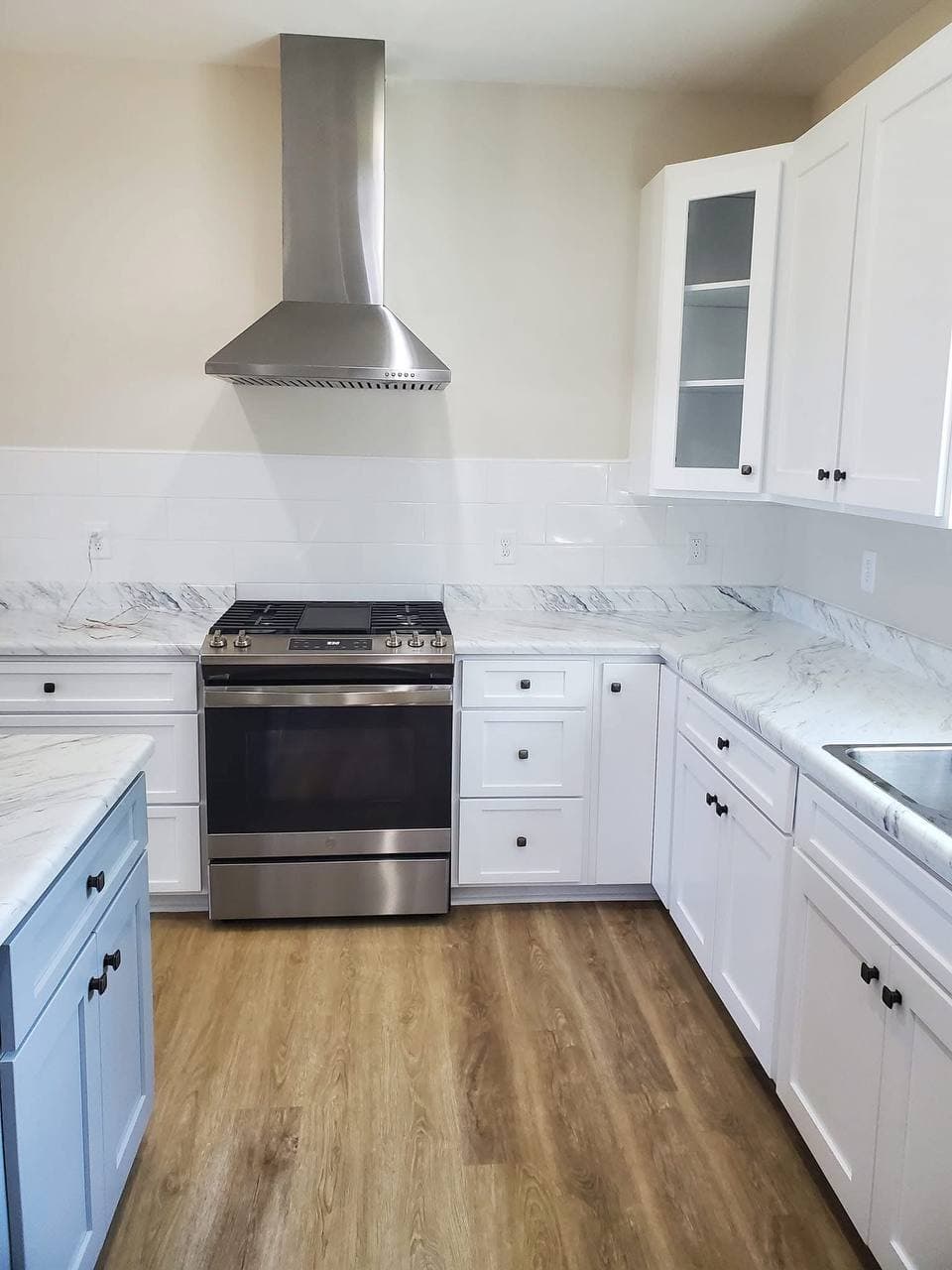 Pristine white kitchen with marble countertops